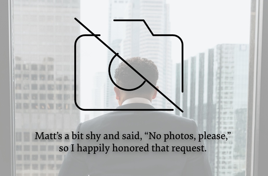 Blurred photo of a man looking outside office window with a camera icon and a text that says "Matt's a bit shy and said, 'No photos, please', so I happily honored that request."