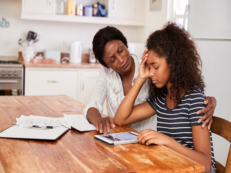 Stressed Teenager with mom beside her and Worried